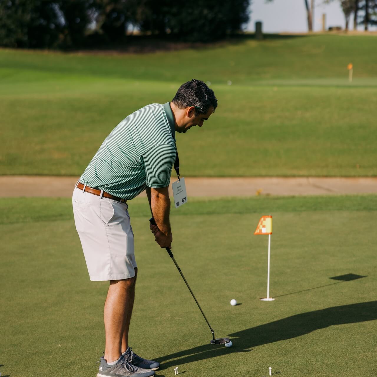 Man putting on golf course